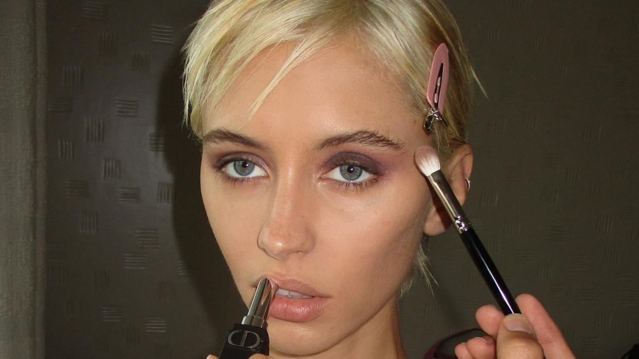 Iris Law poses while getting her makeup done