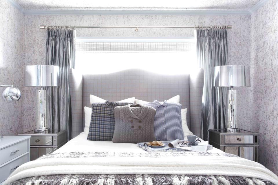 This publicity photo shows a guest bedroom by Designer Brian Patrick Flynn for HGTV.com that turns to wintry menswear for inspiration when creating wintry spaces. It includes a custom headboard made from men's suiting fabric featuring a check print, as well as pillows made from hand-me-down sweaters and flannel shirts. (AP Photo/Brian Patrick Flynn for HGTV.com, Daniel J. Collopy)