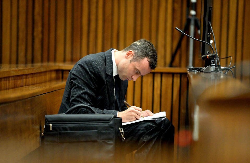 Oscar Pistorius sits in the dock as he listens to cross questioning in the second week of his trial about the events surrounding the shooting death of his girlfriend Reeva Steenkamp, in court during his trial in Pretoria, South Africa, Monday, March 10, 2014. Pistorius is charged with the shooting death of his girlfriend Steenkamp, on Valentines Day in 2013. (AP Photo/Bongiwe Mchunu, Pool)
