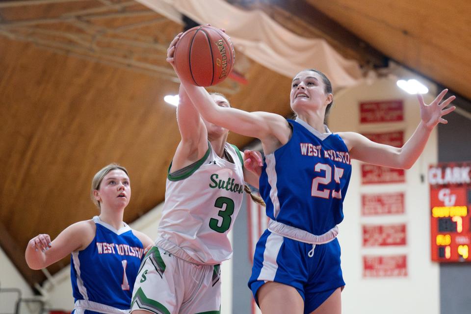 Sutton's Madison Cruz and West Boylston's Shannen Luksha reach for a rebound.