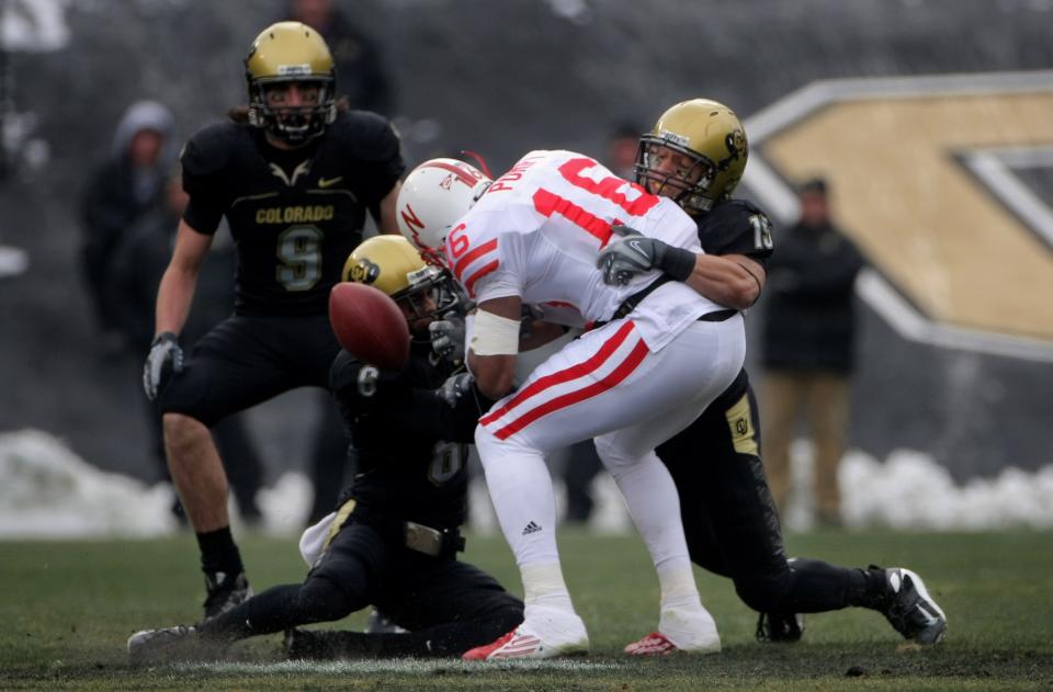 Receiver Maurice Purify of Nebraska Cornhuskers is tackled by Colorado's Gardner McKay (6) and Ryan Walters (15) after making a reception for a first down and then recovering his own fumble at Folsom Field on November 23, 2007. (Photo by Doug Pensinger/Getty Images)