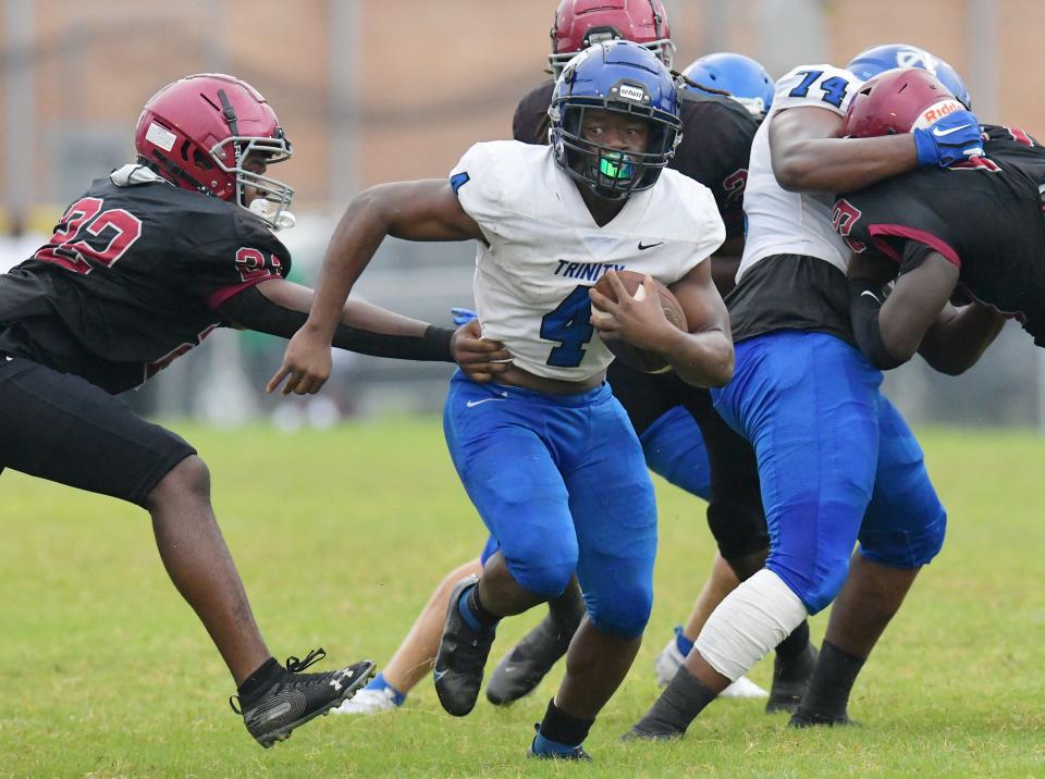 Trinity Christian running back Darnell Rogers (4) tries to escape Raines defenders during the teams' 2021 game. Rogers, who ran for 250 yards in that game, and Trinity host the Vikings on Friday night.