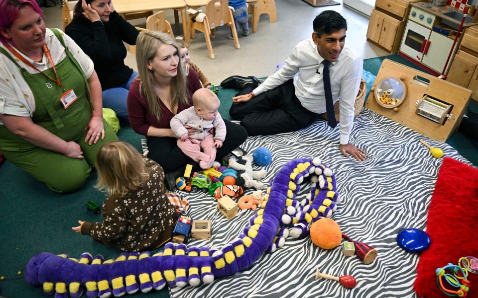 Rishi Sunak takes part in a "stay and play" activity during a visit to a family hub with his wife Akshata Murty, in St Austell, Cornwall, this morning - Ben Stansall /AP