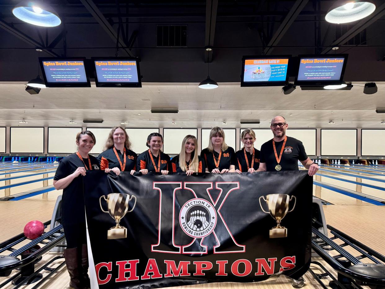 The Marlboro girls bowling team poses with its Section 9 championship banner at Spins Bowl in Poughkeepsie on Feb. 12, 2024. From left: coach Michele Landis, Paige Brooks, Chloe Decker, Emily Tarsio, Olivia Cherubini, Stevie Amato and coach John Morrissey.
