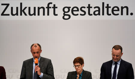 Christian Democratic Union (CDU) candidates Friedrich Merz, Annegret Kramp-Karrenbauer and Jens Spahn attend a regional conference in Luebeck, Germany, November 15, 2018. Slogan reads "Create the future". REUTERS/Fabian Bimmer