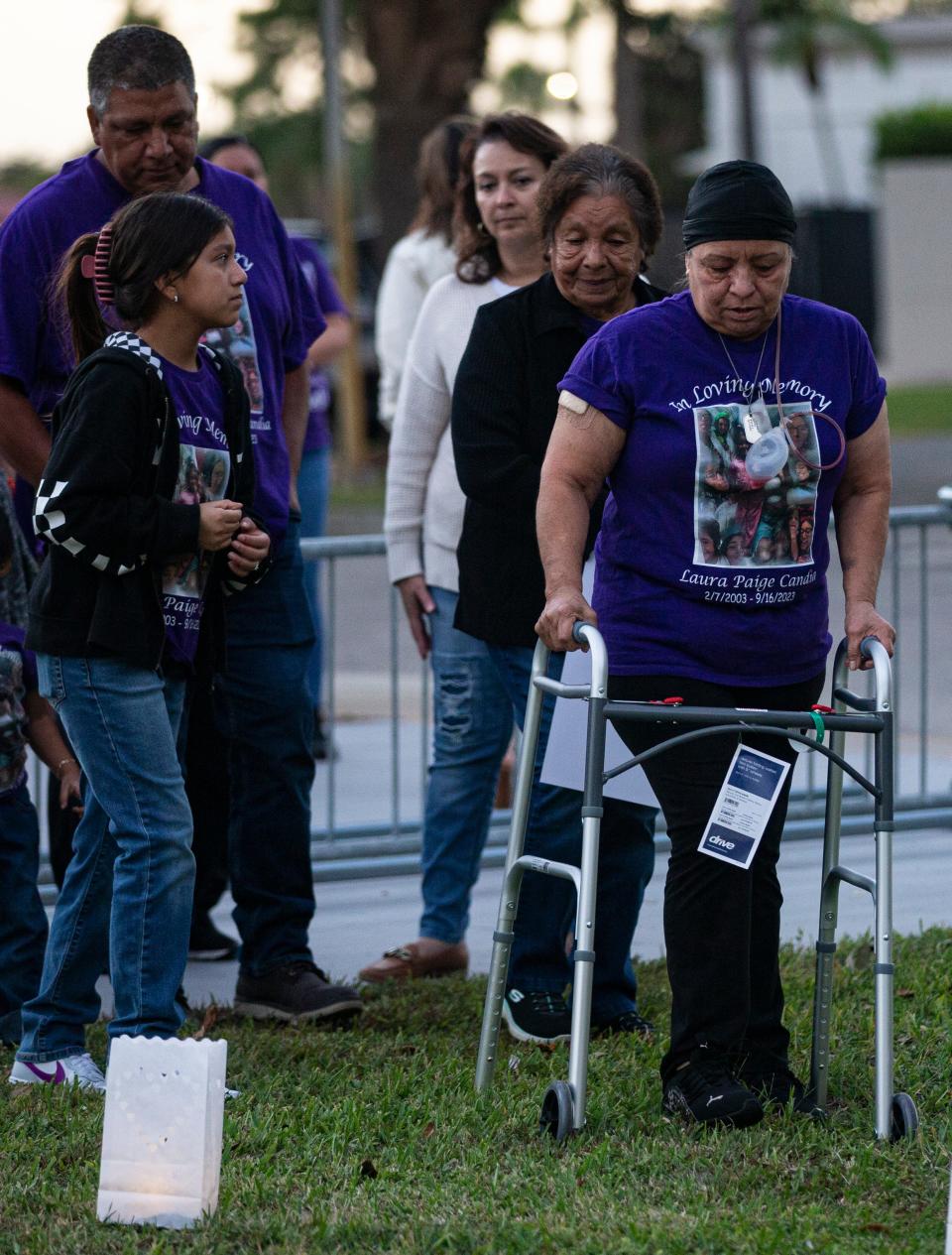 The family of Laura Candia, 20, of Immokalee, attends a candlelight vigil held by The Shelter for Abused Women & Children at the Immokalee Library in Immokalee on Thursday, Oct. 26, 2023. Candia was shot and killed on Sept. 16, 2023 in what authorities say was a domestic violence incident. Candia's grandmother, Olga Welch, front right, was shot multiple times in the incident that killed her granddaughter.