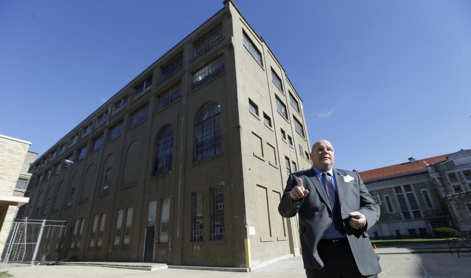 In this Nov. 18, 2013 photo, Warden Nick Ludwick speaks about the history of the Iowa State Penitentiary while standing in the prison yard in Fort Madison, Iowa. The penitentiary, the oldest in use west of the Mississippi River with a history dating back to 1839, is set to close when a $130 million replacement opens down the road next year. City and state officials are discussing how to make the best use of the sprawling and occasionally crumbling prison campus that has been the site of escapes, riots and executions. (AP Photo/Charlie Neibergall)