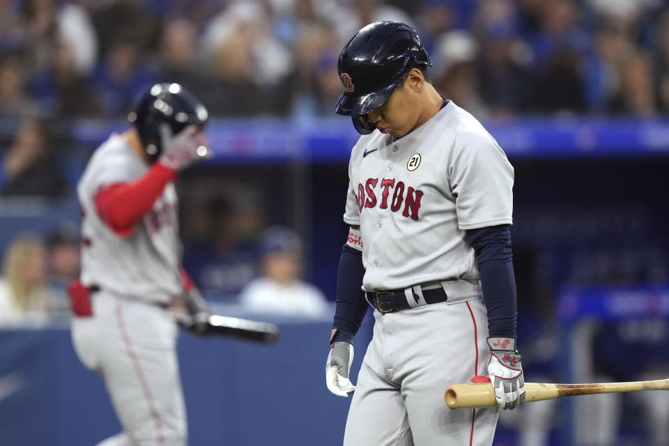 Boston Red Sox Masataka Yoshida, right, reacts after striking out against the Toronto Blue Jays during the second inning of a baseball game Friday, Sept. 15, 2023, in Toronto. (Chris Young/The Canadian Press via AP)