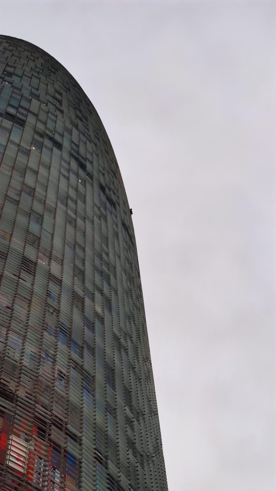 Adam Lockwood, 19, is no stranger to vertigo-inducing free climbing, having been successfully scaling buildings of up to 200 metres in the UK and Europe for the last two years, without any equipment. But his latest venture earlier this week saw Adam add a new challenge to his climbing. For the first time, Adam took on a skyscraper building - the 144-metre (472 feet) Torre Agbar tower in Barcelona, Spain - completely barefoot. The teen, from Manchester, had to keep stopping to rub chalk on his feet to help his grip, as he climbed the ladder-like structure on the outside of the office block.