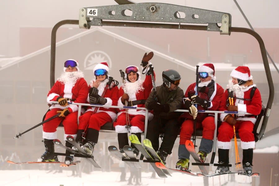 Participants in the annual Santa Sunday fundraiser ride a chairlift, Sunday, Dec. 10, 2023, at the Sunday River ski resort in Newry, Maine. The annual Santa Sunday event raises money for local charities. (AP Photo/Robert F. Bukaty)