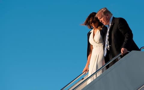 Melania and Donald Trump arrive in Florida - Credit: AFP