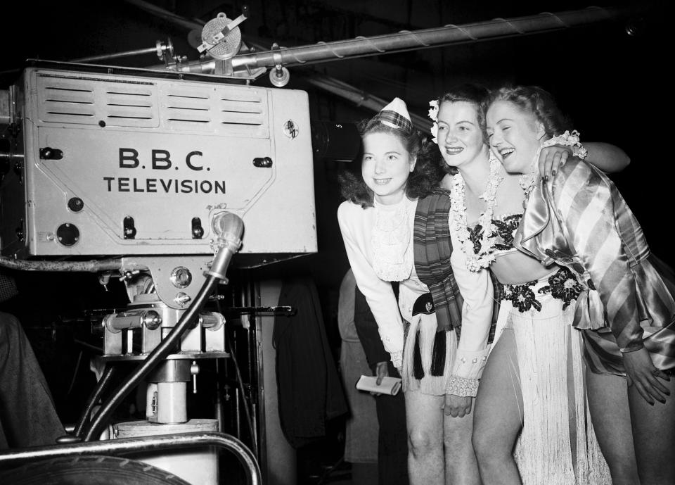 Actresses, Doreen Russell-Roberts (left), Pat Gregory (centre) and Lola Farrell pose in front of a television camera during Radiolympia, 27th September 1949.