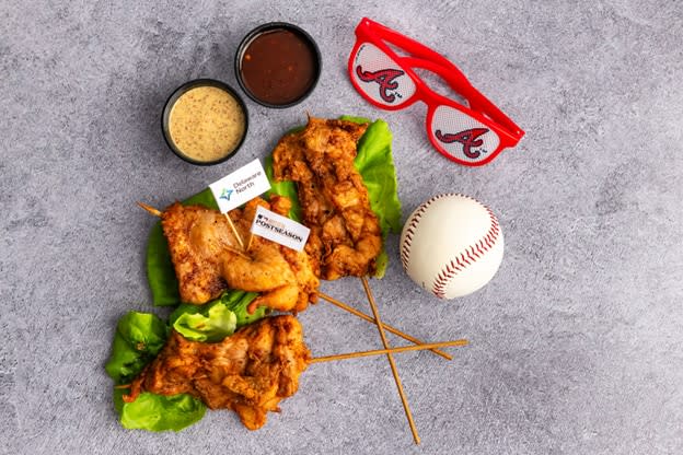•	The Fowl Pole: Trio of skewered sweet tea brined chicken thighs fried to golden crispy perfection. Served with Carolina mustard sauce and Coca-Cola BBQ. Available at Coops Championship Chicken near sections 138 and 320.