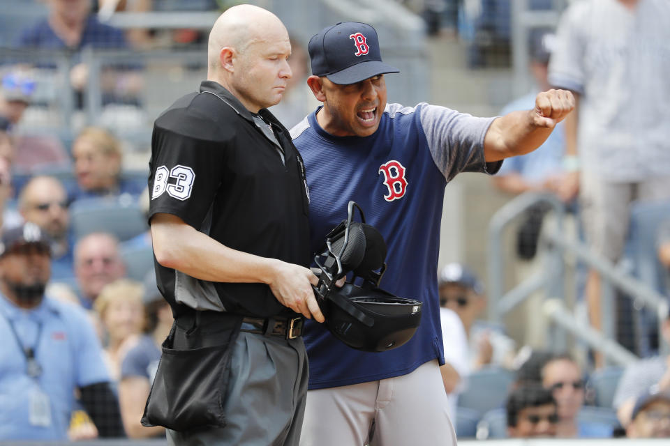 Boston Red Sox manager Alex Cora, left, reacts to umpire Mike Estabrook during a baseball game against the New York Yankees in the fourth inning, Saturday, Aug. 3, 2019, in New York. (AP Photo/Michael Owens)