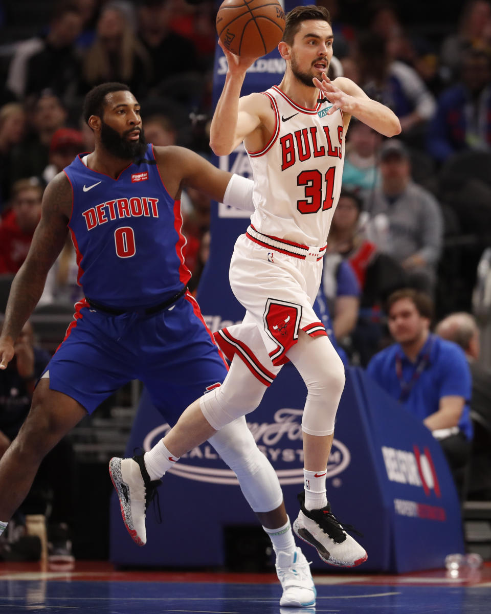 Chicago Bulls guard Tomas Satoransky (31) passes next to Detroit Pistons center Andre Drummond (0) during the first half of an NBA basketball game, Saturday, Jan. 11, 2020, in Detroit. (AP Photo/Carlos Osorio)