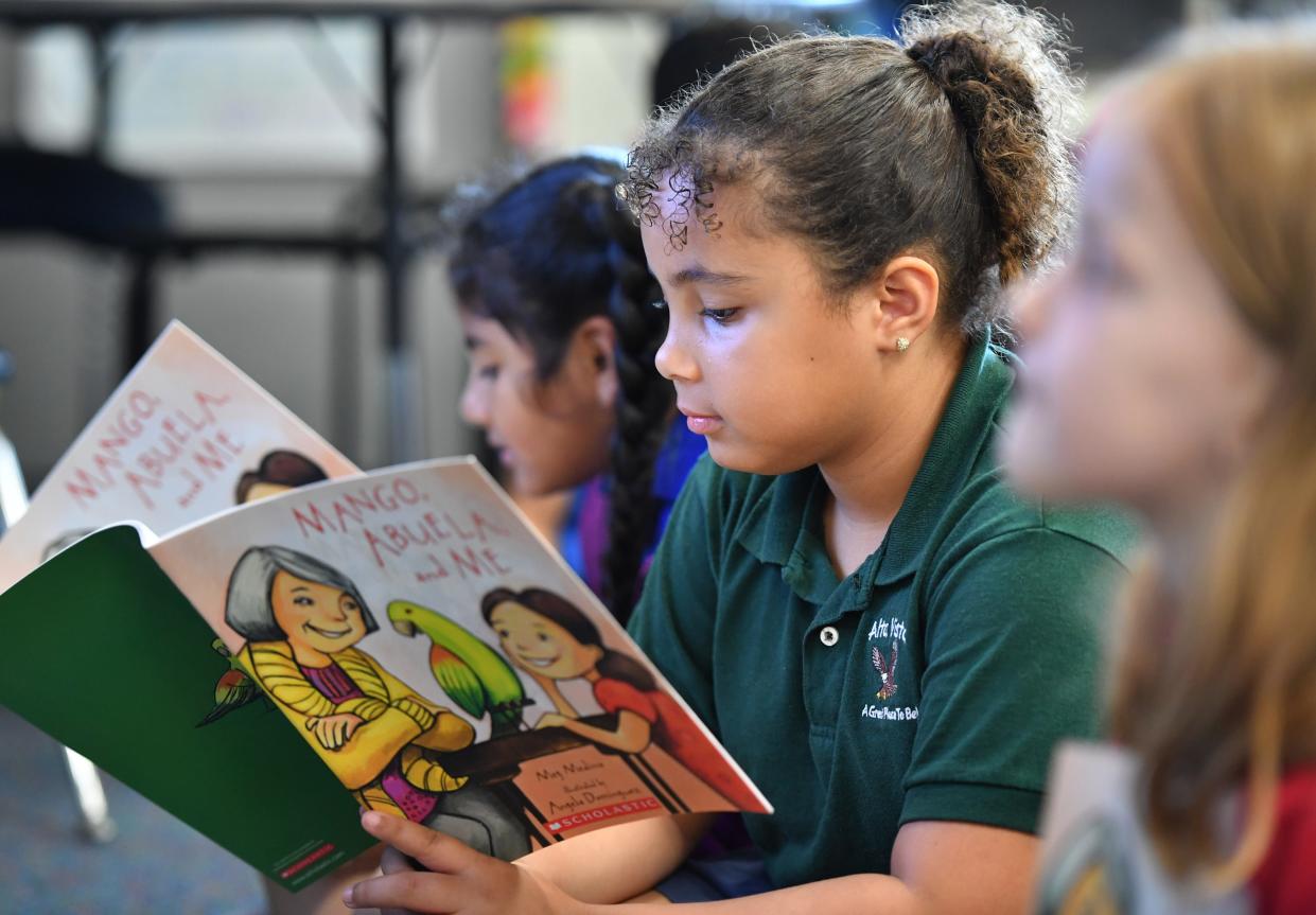 Alta Vista Elementary second-grade student Jada Armstrong reads her copy of "Mango, Abel and Me" in February.