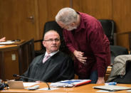 Defendant Swiss man Daniel M., accused of spying on a German tax authority to find out how it obtained details of secret Swiss bank accounts set up by Germans to avoid tax, talks to his lawyer Hannes Linke (L) before the start of his trial on espionage charges, in the Higher Regional Court in Frankfurt am Main, Germany October 18, 2017. REUTERS Andreas Arnold/Pool