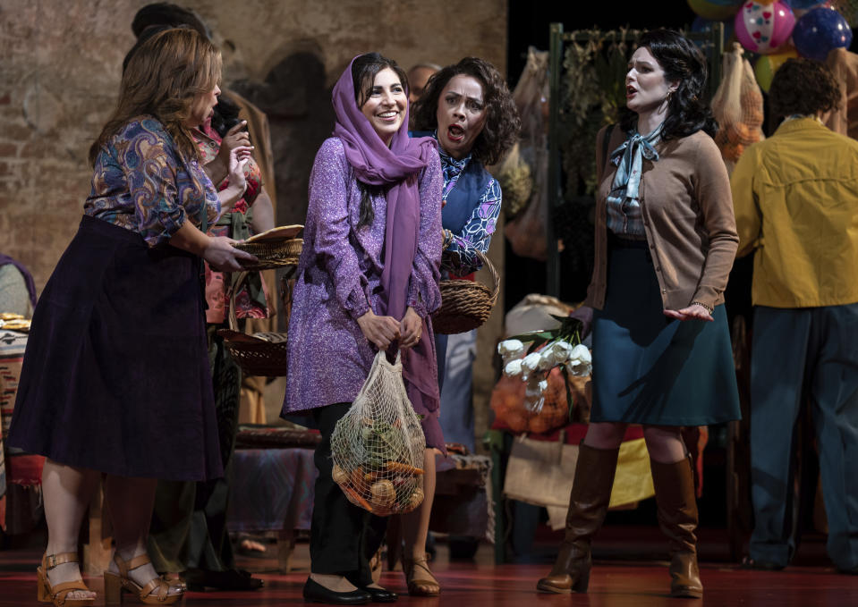 Karin Mushegain, in purple, who portrays Mariam, performs in a dress rehearsal for the opera "A Thousand Splendid Suns," in Seattle, on Wednesday, Feb. 22, 2023. (AP Photo/Stephen Brashear)