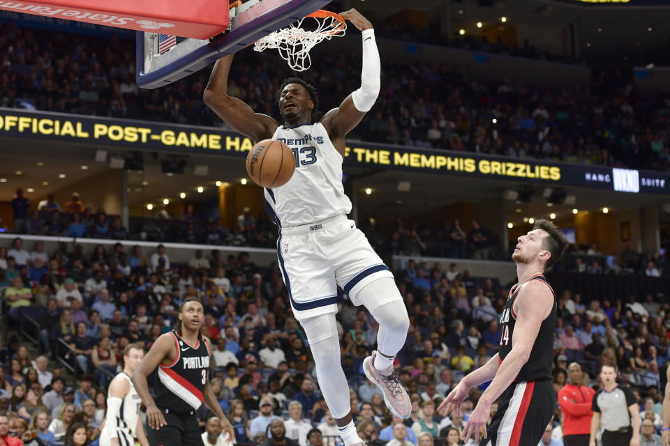 Memphis Grizzlies forward Jaren Jackson Jr. (13) dunks ahead of Portland Trail Blazers forward Drew Eubanks (24) in the second half of an NBA basketball game Tuesday, April 4, 2023, in Memphis, Tenn. (AP Photo/Brandon Dill)