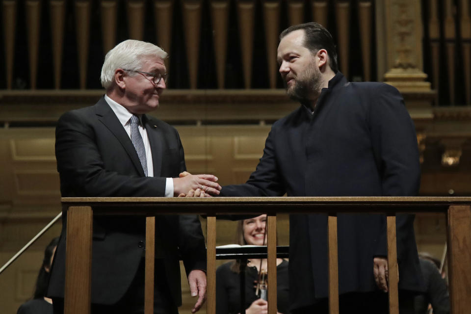German President Frank-Walter Steinmeier, left, shakes hands with BSO conductor Andris Nelsons prior to a joint concert of the Boston Symphony Orchestra and Germany's visiting Leipzig Gewandhaus Orchestra, Thursday, Oct. 31, 2019, at Symphony Hall in Boston. (AP Photo/Elise Amendola)