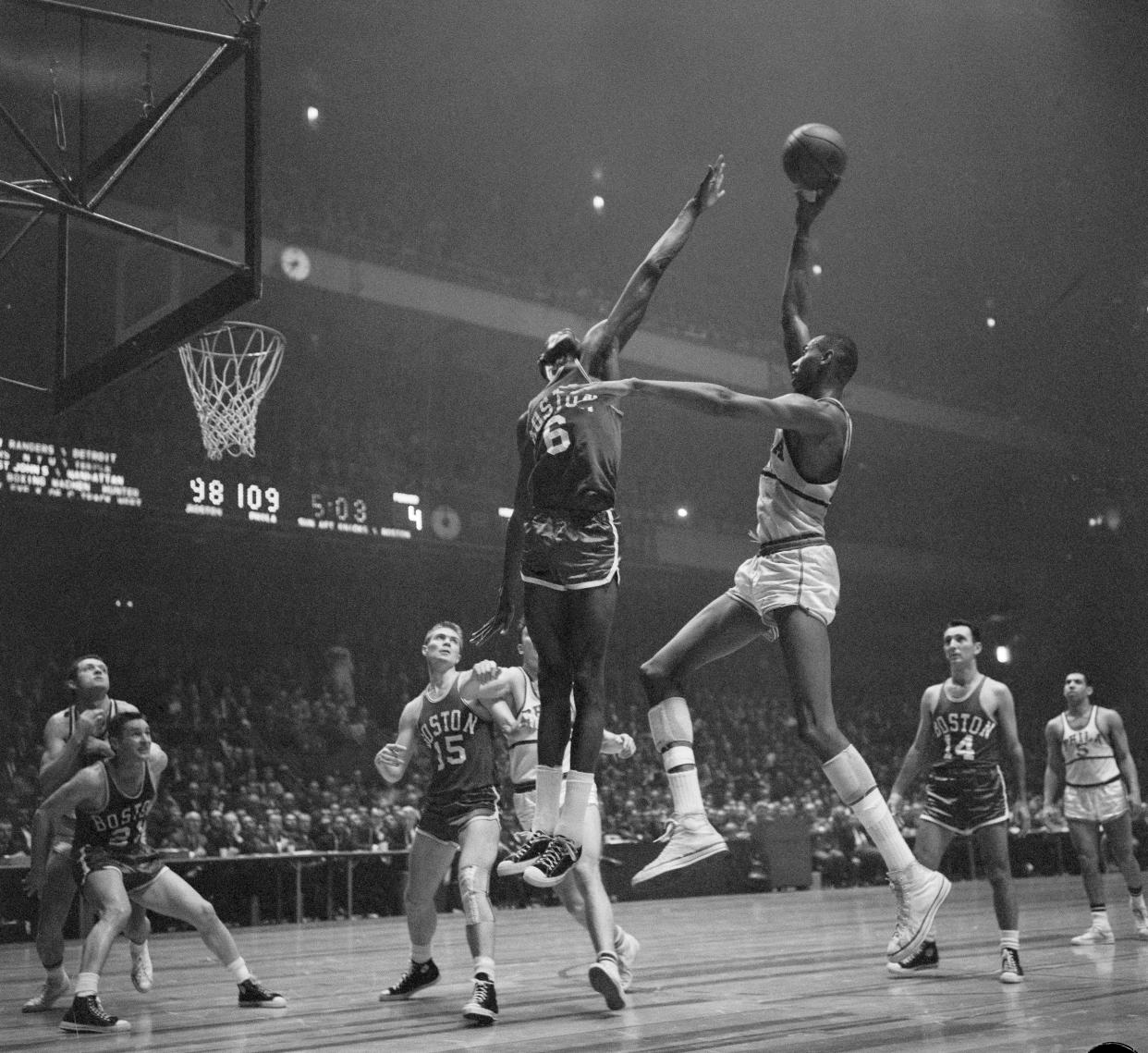 Bill Russell (6) of Boston in on action as Wilt Chamberlain (13) of Philadelphia misses basket.