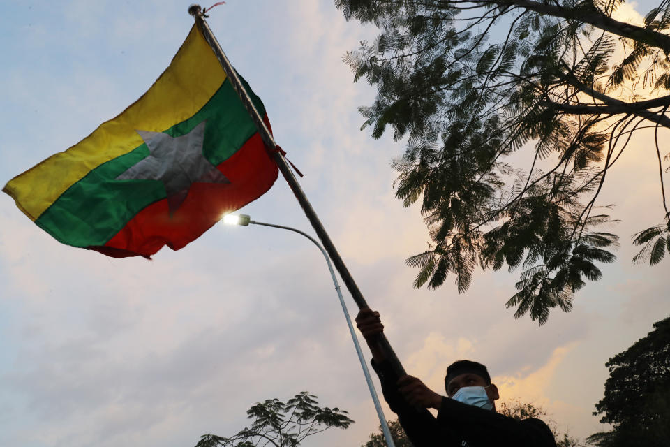 A protester waves a Myanmar flag during protesters in Mandalay, Myanmar, on Monday, Feb. 8, 2021. Tension in the confrontations between the authorities and demonstrators against last week's coup in Myanmar boiled over Monday, as police fired a water cannon at peaceful protesters in the capital Naypyitaw. (AP Photo)