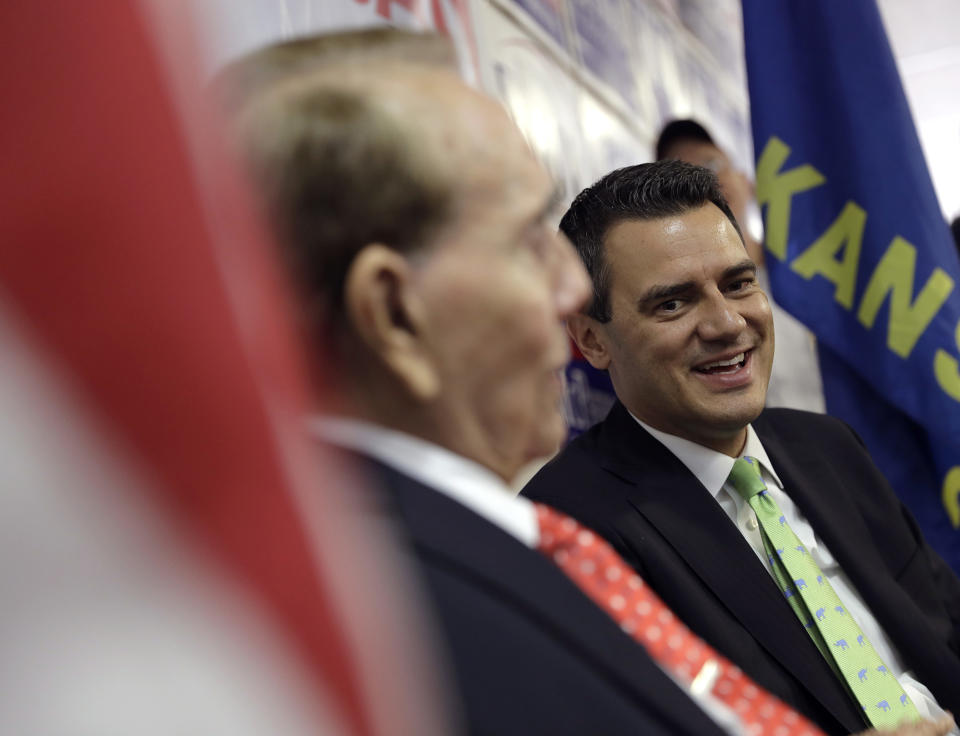 Rep. Kevin Yoder, right, with former Sen. Bob Dole at the Johnson County Republican headquarters in Overland Park, Kan. on Oct. 21. Democrats believe Yoder is vulnerable in his suburban Kansas City district because Trump and the state's GOP governor are seen as unpopular there. (Photo: Charlie Riedel/AP)