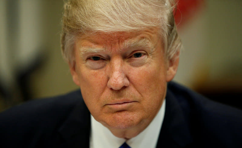 FILE PHOTO: U.S. President Donald Trump looks up while hosting a House and Senate leadership lunch at the White House in Washington, U.S. March 1, 2017.  REUTERS/Kevin Lamarque/File Photo