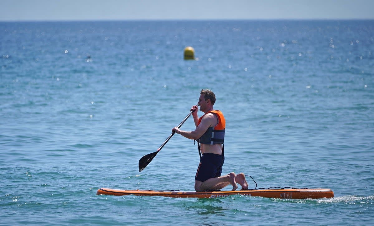 The RNLI and British Canoeing are urging people to prioritise their safety before taking a dip across UK shores (PA)