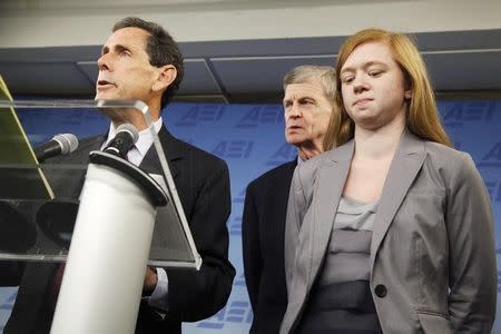 Abigail Fisher (R), a suburban Houston student who asserted she was wrongly rejected by the University of Texas at Austin while minority students with similar grades and test scores were admitted thanks to the admissions policy, and her father Richard Fisher (C) stand by as Edward Blum, director of the Project on Fair Representation, speaks at a news conference in Washington, June 24, 2013. REUTERS/Jonathan Ernst