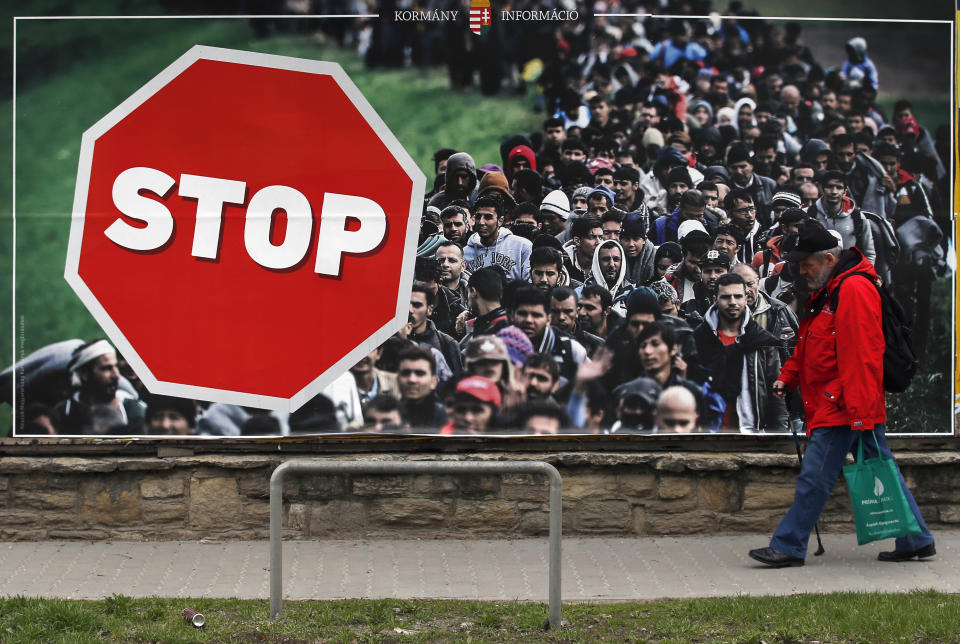 FILE - In this Saturday, April 7, 2018, file photo, a man walks by an anti-migration billboard from the Hungarian government, on a street in Budapest, Hungary. With a campaign centered on stopping immigration, Hungary’s ruling Fidesz party is expected to continue its dominance in the European Parliament election at the end of May. While Hungary has been practically closed to immigrants from the Middle East, Asia and Africa since Prime Minister Viktor Orban had border fences built in 2015, he continues to warn voters about the threat of a “migrant invasion” that would put at risk Europe’s Christian culture. (AP Photo/Darko Vojinovic, File)