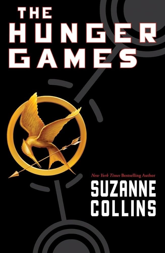 Cover of "The Hunger Games" by Suzanne Collins featuring a golden pin with a mockingjay