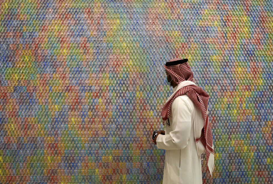 In this June 27, 2021 photo, a Saudi man looks at an artwork by Korean artist Do Ho Suh at King Abdulaziz Center for World Culture, also known as Ithra, in Dammam, Saudi Arabia. The center was built by Saudi Aramco and inaugurated by King Salman in 2016. (AP Photo/Amr Nabil)