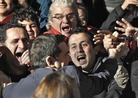 Opposition leader and head of radical leftist Syriza party Alexis Tsipras is greeted by supporters outside his campaign headquarters in Athens, January 25, 2015. REUTERS/Alkis Konstantinidis