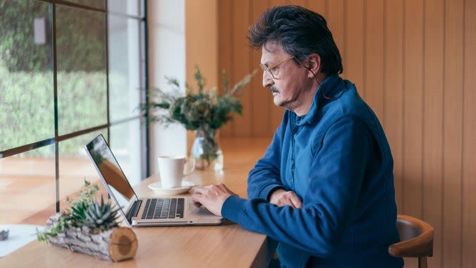 Senior man using laptop.