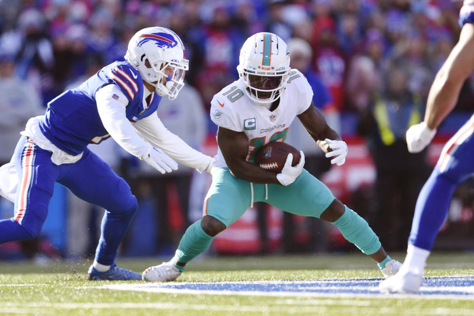 Miami Dolphins wide receiver Tyreek Hill (10) carries the ball during the first half of an NFL wild-card playoff football game against the Buffalo Bills, Sunday, Jan. 15, 2023, in Orchard Park, N.Y. (AP Photo/Adrian Kraus)