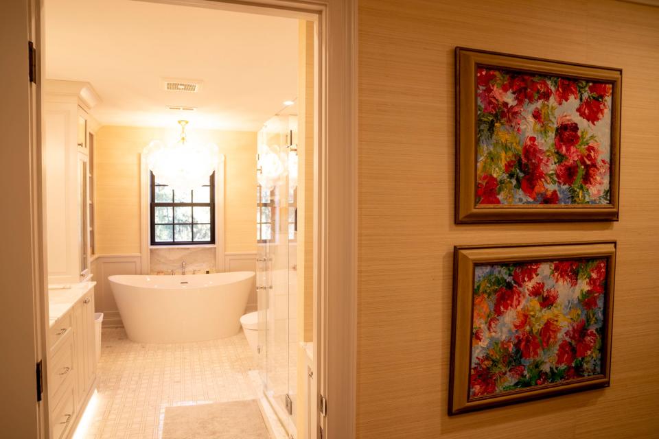 This bathroom is lined with grass cloth wallpaper.