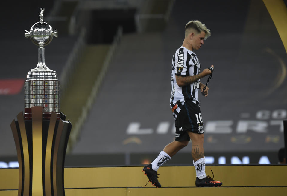 Soteldo of Brazil's Santos walks past the Copa Libertadores trophy after his team lost against Brazil's Palmeiras during a Copa Libertadores final soccer match at the Maracana stadium in Rio de Janeiro, Brazil, Saturday, Jan. 30, 2021. Palmeiras won 1-0. (Mauro Pimentel/Pool via AP)