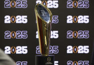 The National Championship Trophy is displayed following a press conference at Mercedes-Benz Stadium, Tuesday, Aug. 16, 2022, in Atlanta, announcing that the CFP National Championship NCAA college football game will be played at Mercedes-Benz Stadium in 2025. (Jason Getz/Atlanta Journal-Constitution via AP)