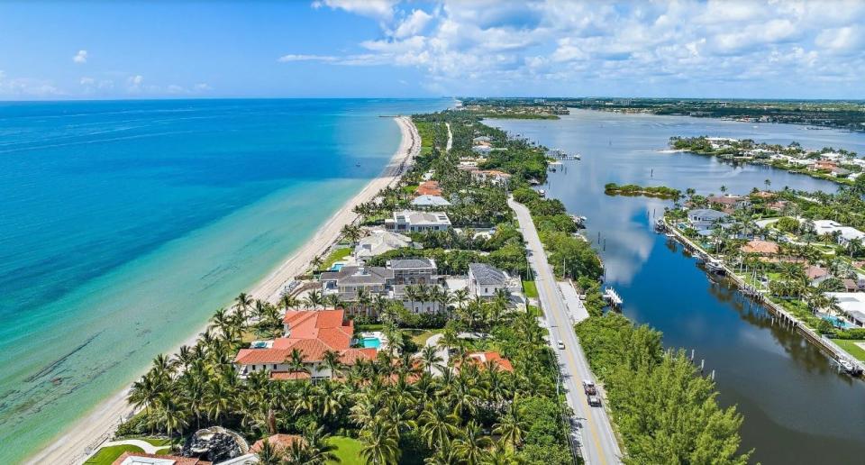 Seen with the red roof in the foreground, an estate at 1400 S. Ocean Blvd. stretches between the Atlantic Ocean and the Intracoastal Waterway in Manalapan near Palm Beach. The property was just listed for $64.995 million.