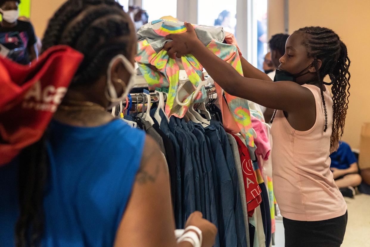 FILE - Children and parents pick out their clothing during Back to School Giveaway event on Sunday, July 24, 2022 in Athens. This year's giveaway at Cedar Shoals High School will be held Sunday, July 30, 2023.