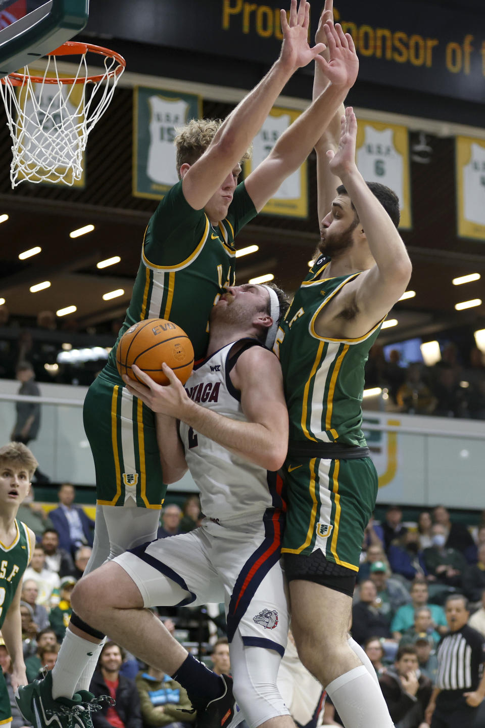 Gonzaga forward Drew Timme, center, shoots from between San Francisco forward Zane Meeks, left, and center Saba Gigiberia during the first half of an NCAA college basketball game in San Francisco, Thursday, Jan. 5, 2023. (AP Photo/Jed Jacobsohn)