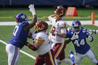 Washington Football Team offensive guard Wes Schweitzer (71) blocks New York Giants' Dexter Lawrence (97) as quarterback Kyle Allen (8) throws a pass during the first half of an NFL football game Sunday, Oct. 18, 2020, in East Rutherford, N.J. (AP Photo/John Minchillo)