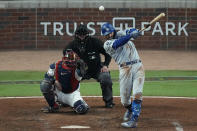 Los Angeles Dodgers' Chris Taylor hits a two-run double during the seventh inning against the Atlanta Braves in Game 2 of baseball's National League Championship Series Sunday, Oct. 17, 2021, in Atlanta. (AP Photo/John Bazemore)