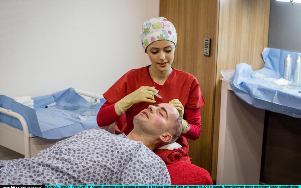 A patient undergoes a hair transplant - Getty Images Europe