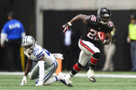 Atlanta Falcons running back Tevin Coleman (26) runs past Dallas Cowboys free safety Xavier Woods (25) during the second half of an NFL football game, Sunday, Nov. 18, 2018, in Atlanta. (AP Photo/John Amis)