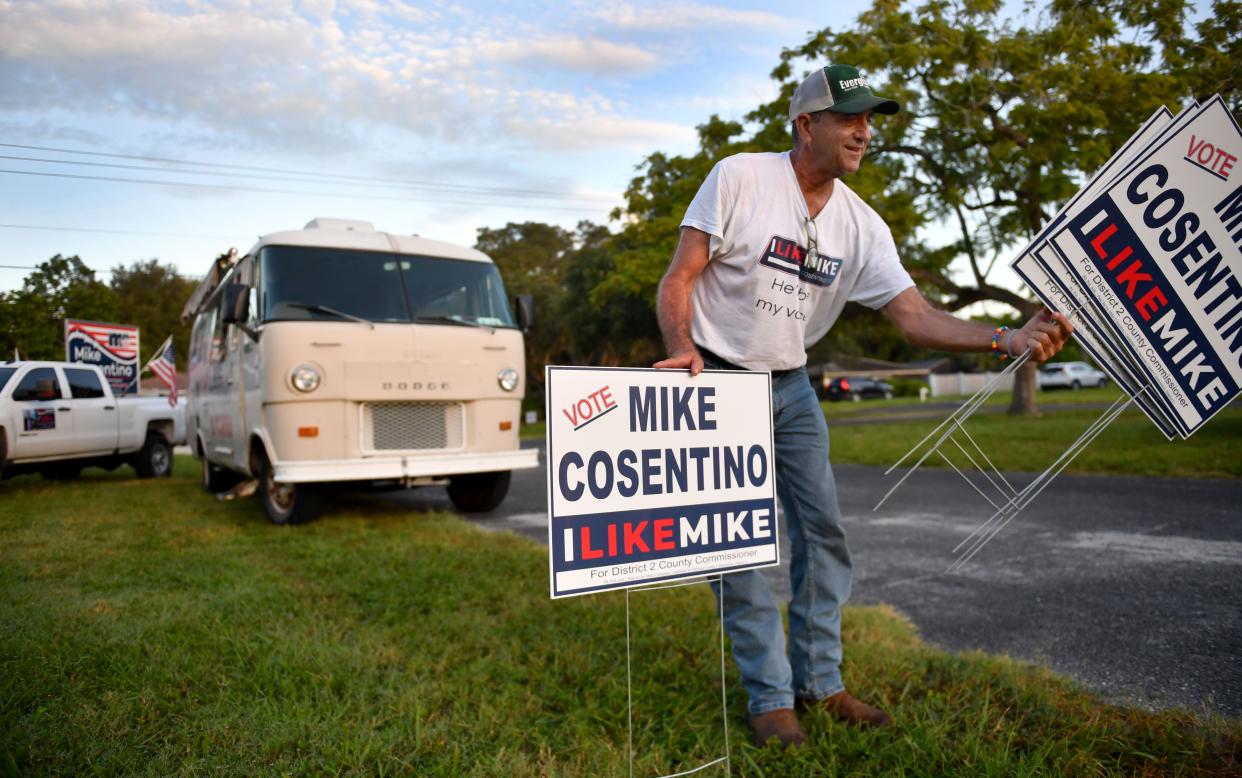 Mike Cosentino, a Democratic candidate for Sarasota County Commission, puts up campaign signs early on primary day, Aug. 23, outside the polling place at Trinity United Methodist Church, in Sarasota. Fredd Atkins won the Democratic primary in a three-way race.