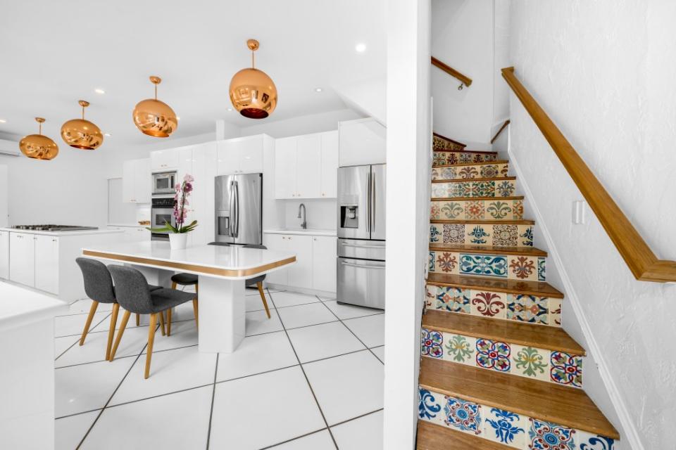 The eat-in kitchen and colorful tiled stairs. 1OAKSTUDIOS