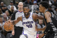 Sacramento Kings' Harrison Barnes (40) drives against San Antonio Spurs' Josh Richardson, right, during the first half of an NBA basketball game, Sunday, Jan. 15, 2023, in San Antonio. (AP Photo/Darren Abate)