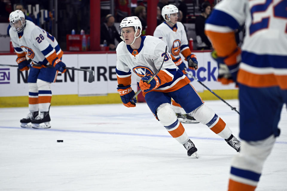 New York Islanders center Kyle MacLean (32) warms up before an NHL hockey game against the Chicago Blackhawks, Friday, Jan. 19, 2024, in Chicago. His father, John Maclean, is the Islanders' assistant coach. (AP Photo/Matt Marton)